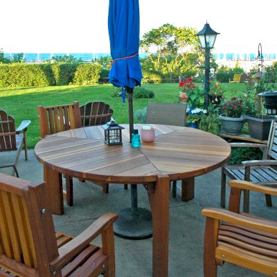 Lisa's Retro Outdoor Patio Table (Options: 5.5' Diameter, Chairs, California Redwood, with 3 Ruth Chairs, No Cushions, Standard Tabletop, No Lazy Susan, 1 5/8" Umbrella Hole, Transparent Premium Sealant). Photo Courtesy of Russell C. & Carmen A. of Milwaukee, Wisconsin.