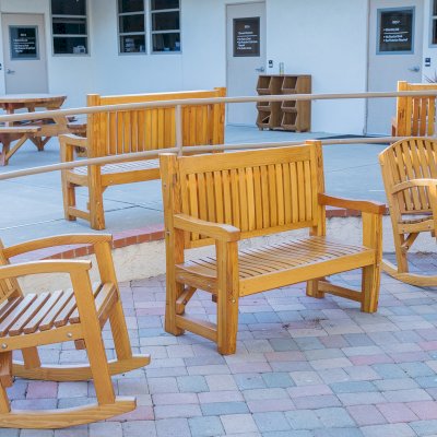 Luna Wood Rocking Chairs (Options: Standard Width, Tall, Douglas-fir, No Cushion, Transparent Premium Sealant). Photo Also Shows a Few Ti Amo Benches. Installed in Vanguard University [55 Fair Dr, Costa Mesa, CA].
