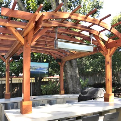 Marin Outdoor Kitchen Pergola (Options: 14' L x 14' Arc W, California Redwood, Unattached, 2 Post Electrical Wiring Trim, 4-Post Anchor Kit for Stone, No Ceiling Fan Base, No Privacy, No Curtain Rods, 9 ft Post Height (front posts wrapped with masonry), Transparent Premium Sealant). Photo Courtesy of C. Funkhouser of Hillsborough, California.