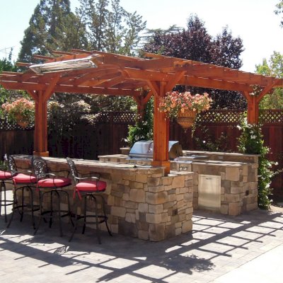 Marin Outdoor Kitchen Pergola (Options: 14' L x 16' Arc W, California Redwood, Unattached, 2 Post Electrical Wiring Trim, Arched Roof without Lattice Panels, 4-Post Anchor Kit for Stone, No Ceiling Fan Base, No Privacy, No Curtain Rods, 9 ft Post Height (front posts wrapped with masonry), Transparent Premium Sealant). 