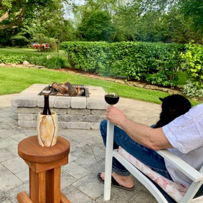 Mini 12 Inch Round Wood Side Table (Options: California Redwood, 18 inches Tall, Transparent Premium Sealant, Base Timbers 14" Long by Custom Request). Photo Courtesy of K. M. Wells of Oswego, New York.