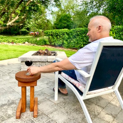 Mini 12 Inch Round Wood Side Table (Options: California Redwood, 18 inches Tall, Transparent Premium Sealant, Base Timbers 14" Long by Custom Request). Photo Courtesy of K. M. Wells of Oswego, New York.