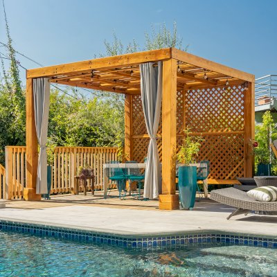 Modern Louvered Garden Pergola (Options: 12' L x 12' W, 8'' x 8'' Posts, Mobile Louvers, Douglas-fir, with 1 Lattice Privacy Wall, Electrical Wiring Trim for 1 Post, Without Fascia, No Curtain Rods, 4 Post Anchor Kit for Wood, No Post Decorative Trims, No Ceiling Fan Base, Transparent Premium Sealant). Photo Courtesy of S. Weinswig of Los Angeles, CA.