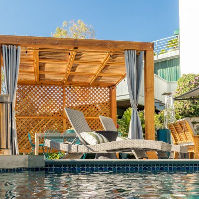 Modern Louvered Garden Pergola (Options: 12' L x 12' W, 8'' x 8'' Posts, Mobile Louvers, Douglas-fir, with 1 Lattice Privacy Wall, Electrical Wiring Trim for 1 Post, Without Fascia, No Curtain Rods, 4 Post Anchor Kit for Wood, No Post Decorative Trims, No Ceiling Fan Base, Transparent Premium Sealant). Photo Courtesy of S. Weinswig of Los Angeles, CA.