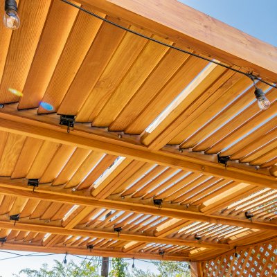 Modern Louvered Garden Pergola (Options: 12' L x 12' W, 8'' x 8'' Posts, Mobile Louvers, Douglas-fir, with 1 Lattice Privacy Wall, Electrical Wiring Trim for 1 Post, Without Fascia, No Curtain Rods, 4 Post Anchor Kit for Wood, No Post Decorative Trims, No Ceiling Fan Base, Transparent Premium Sealant). Photo Courtesy of S. Weinswig of Los Angeles, CA.
