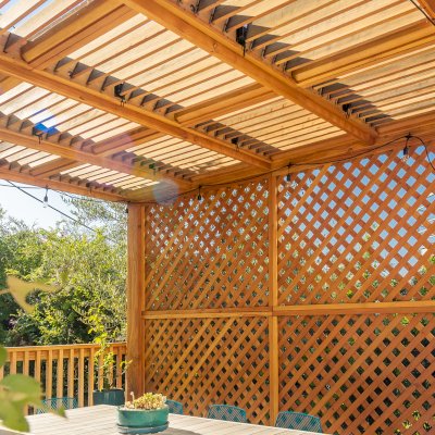 Modern Louvered Garden Pergola (Options: 12' L x 12' W, 8'' x 8'' Posts, Mobile Louvers, Douglas-fir, with 1 Lattice Privacy Wall, Electrical Wiring Trim for 1 Post, Without Fascia, No Curtain Rods, 4 Post Anchor Kit for Wood, No Post Decorative Trims, No Ceiling Fan Base, Transparent Premium Sealant). Photo Courtesy of S. Weinswig of Los Angeles, CA.