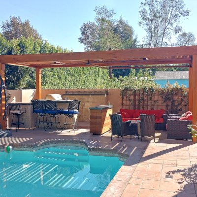 Modern Louvered Garden Pergola (Options: 25' L x 10' W, 8'' x 8'' Posts, Mobile Louvers, Douglas-fir, No Privacy Wall, Electrical Wiring Trim for 2 Posts, Without Fascia, 4 Curtain Rods, 4 Post Anchor Kit for Concrete, No Post Decorative Trims, 2 Ceiling Fan Bases, Transparent Premium Sealant). Photo Courtesy of B. Hamideh of Studio City, CA.
