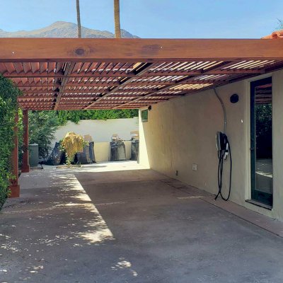 Custom Attached Modern Louvered Garden Pergola (Options: 34' L x 14' W, 8'' x 8'' Posts, Mobile Louvers, Mature Redwood, No Electrical Wiring Trim, Without Fascia, No Curtain Rods, 3 Post Anchor Kit for Concrete, No Post Decorative Trims, No Ceiling Fan Base, Transparent Premium Sealant). Photo Courtesy of G. Richter of Palm Springs, CA.