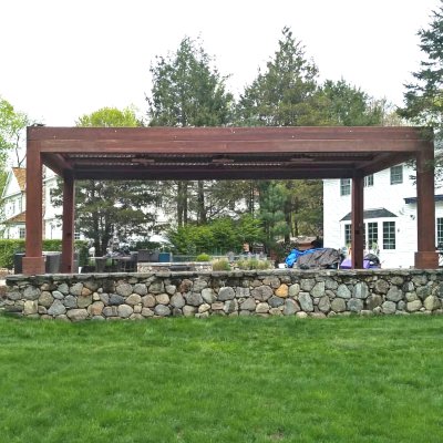 Modern Louvered Garden Pergola (Options: 24' L x 12' W, 10'' x 10'' Posts, Mobile Louvers, California Redwood, 10 ft H [2 Posts Shorter Seating Atop the Pony Wall], No Electrical Wiring Trim, 4 Curtain Rods, 4 Post Anchor Kit for Concrete, No Post Decorative Trims, 2 Ceiling Fan Bases, Coffee-Stain Premium Sealant). Photo Courtesy of J. VanderKamp of Westport, Connecticut.
