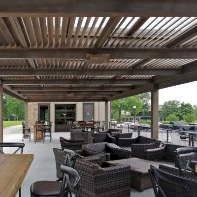 Modern Louvered Garden Pergola (Options: 44' L x 18' W, 8'' x 8'' Posts, Mobile Louvers, Douglas-fir, 10 ft H, No Electrical Wiring Trim, 4 Curtain Rods, 6 Post Anchor Kit for Concrete, With Clear Polycarbonate Roofing Atop Pergola Framing by Custom Request, No Post Decorative Trims, No Ceiling Fan Bases, Coffee-Stain Premium Sealant). Photo Courtesy of M. Hudson of Rogers, Arkansas.