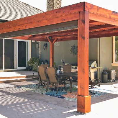 Modern Louvered Garden Pergola (Options: 20' L x 15' W, 8'' x 8'' Posts, Mobile Louvers, Mature Redwood, 9.5 ft H, 1 Electrical Wiring Trim, 4-Post Anchor Kit for High-Wind, No post decorative trims, No Ceiling Fan Base, Transparent Premium Sealant). Retractable Motorized Shade is a Sunroll from Sunesta Retractable Screens, for more information: https://www.sunesta.com/products/the-sunroll. Photo Courtesy of D. Ruprecht of Hollister, CA.