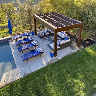 Modern Louvered Garden Pergola (Options: 16' L x 12' W, 10'' x 10'', Fixed Louvers, Douglas-fir, 9.5 ft H, No Electrical Wiring Trim Kit, 4 Post Anchor Kit for Concrete, No Post Decorative Trims, No Ceiling Fan Base, 4 Curtain Rods, Coffee Stain Sealant). Photo Courtesy of R. McCan of El Dorado Hills, CA