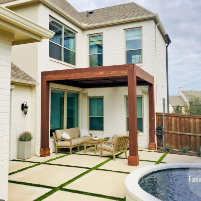Custom Modern Louvered Garden Pergola (Options: 12' L x 12' W, 10'' x 10'' Posts, Mobile Louvers, California Redwood, 10 ft H, No Electrical Wiring Trim, 3 Post Anchor Kit for Concrete, No post decorative trims, No Ceiling Fan Base, Coffee-Stain Premium Sealant). The Modern Louvered Pergola can be altered to be attached to a building by eliminating one or more posts like this image shows. Photo Courtesy of S. Wottle of Frisco, Texas.