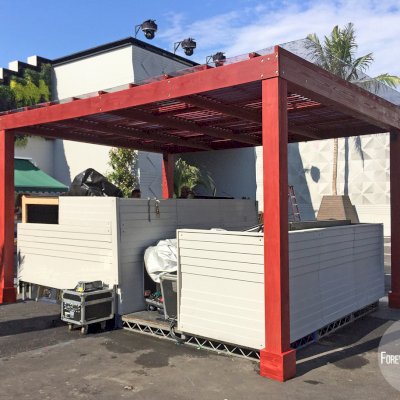 Modern Louvered Garden Pergola (Options: 14' L x 18' W, 6'' x 6'' Posts by Custom Request, Mobile Louvers, California Redwood, 10ft H, Electrical Wiring Trim for 1 Post, 4 Post Anchor Kit for Concrete, No post decorative trims, Add a Ceiling Fan Base, 2 Curtain Rods, Cherry Stain Premium Sealant). Photo taken by our install crews while site still in flux. Photo included her to highlight custom designed framed polycarbonate panels added as a top roof layer to make the Modern Louvered Pergola also waterproof. Photo Courtesy of Dizon of Brooklyn, NY.
