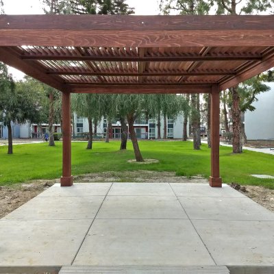 Modern Louvered Garden Pergola (Options: 14' L x 14' W, 8'' x 8'' Posts, Fixed Louvers, California Redwood, 9.5 ft H, No Electrical Wiring Trim, 4 Post Anchor Kit for Concrete, No post decorative trims, With a Ceiling Fan Base, Coffee-Stain Premium Sealant). Photo Courtesy of M. Ramirez of Long Beach, CA.