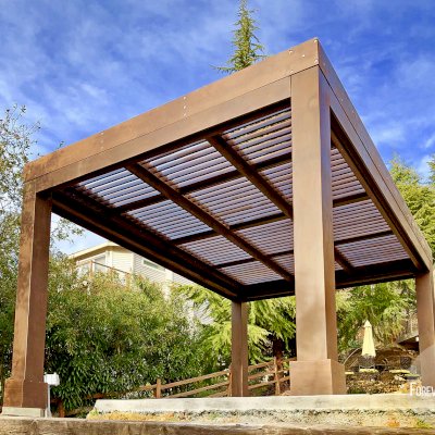Modern Louvered Garden Pergola (Options: 16' L x 12' W, 10'' x 10'', Fixed Louvers, Douglas-fir, 9.5 ft H, No Electrical Wiring Trim Kit, 4 Post Anchor Kit for Concrete, No Post Decorative Trims, No Ceiling Fan Base, 4 Curtain Rods, Coffee Stain Sealant). Photo Courtesy of R. McCan of El Dorado Hills, CA