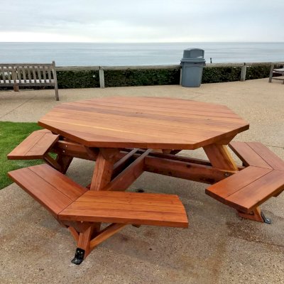 Octagonal Picnic Table (Options: 5' Diameter Tabletop, Attached Benches, California Redwood, Standard Tabletop, 1 5/8" Umbrella Hole, Transparent Premium Sealant). Photo Courtesy of G. Cooley of Dana Point, CA.