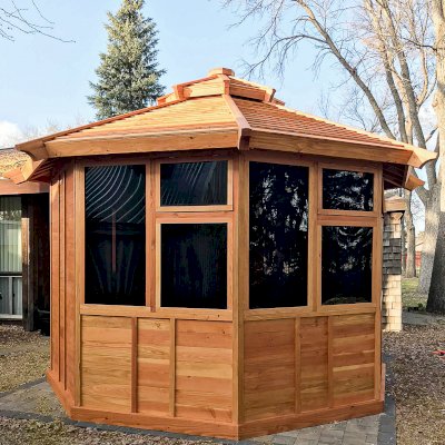 Octagonal Sunroom Gazebo (Options: 12', Deck, Douglas-fir, 36" H Siding Below Windows, Standard Wood Roof, 4 Window Panels, Single Door, Transparent Premium Sealant). Photo Courtesy of R. Voyles of Aberdeen, South Dakota.