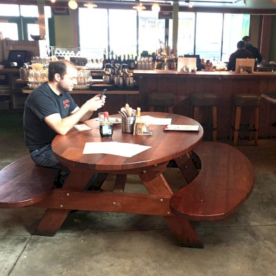 Custom Oval Picnic Table (Options: Old-Growth Redwood, Extra Wide Benches by Custom Request, Transparent Premium Sealant). Photo Courtesy of Chow's Restaurant in 3770 Piedmont Avenue, Oakland, CA.