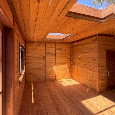 Custom Palo Alto Backyard Cabin (Options: 18' L, 16' W, With 19' x 19' Structural Deck with Steps, California Redwood for Exterior Finished, Douglas-fir Internal Walls and Framing, Double Door, Slidding Windows, Windows Purchased Locally, With Two 2' x 2' Skylights, Metal Roof, Electrical Wire Trim on the Walls, Transparent Premium Sealant). Photo Courtesy of R. and M. Hegwood of Ceres, CA.