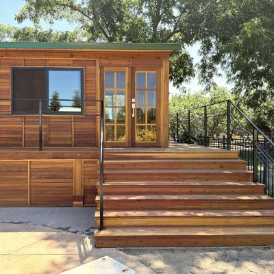 Custom Palo Alto Backyard Cabin (Options: 18' L, 16' W, With 19' x 19' Structural Deck with Steps, California Redwood for Exterior Finished, Douglas-fir Internal Walls and Framing, Double Door, Slidding Windows, Windows Purchased Locally, With Two 2' x 2' Skylights, Metal Roof, Electrical Wire Trim on the Walls, Transparent Premium Sealant). Photo Courtesy of R. and M. Hegwood of Ceres, CA.