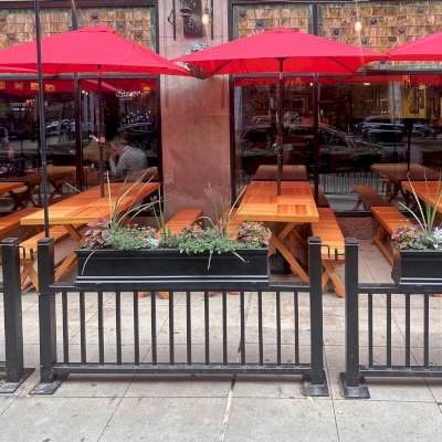 Rectangular Folding Picnic Tables (Options: 7' L x 30'' W, Folding Side Benches, Mosaic Douglas-Fir,  1 Full Length Bench/Side, Seamless Tabletop, Checkerboard Design Tabletop, 2'' Umbrella Hole,  Transparent Premium Sealant). Tables Installed in Elephant and Castle Restaurant, 185 N Wabash Ave, Chicago, IL 60601.