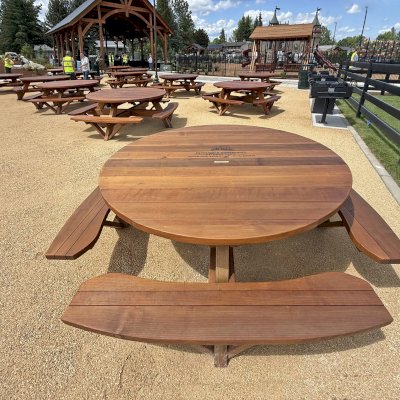Round Wooden Picnic Tables (Attached Benches) (Options: 6' Diameter, Mature Redwood, Custom Engraving, Transparent Premium Sealant). Installed in Faith Walk Community Fitness Park in Coeur d'Alene, Idaho.