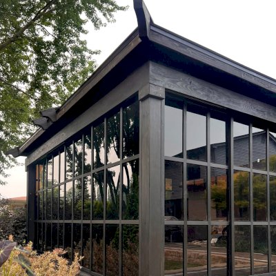 Sun Gazebo with Sliding Doors (Options: Custom Size 18' L x 15' W, Douglas-Fir, 8 ft Wall Height, 3 Sliding Walls and One Fixed Wood Wall, Without Skylight, Complete Floor, 1 Ceiling Fan Base, 1 TV Mount, Shiplap Roof, Black Stain Premium Sealant). Photo Courtesy of W. Geisert of Troy, MI.