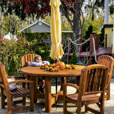 Sunset Patio Table (Options: 5' Diameter, With Chairs, Mature Redwood, 4 Luna Armchairs, No Cushions, Standard Tabletop, No Lazy Susan, 1 5/8" Umbrella Hole, Transparent Premium Sealant). Photo Courtesy of L. Scalise of Oakdale, NY.