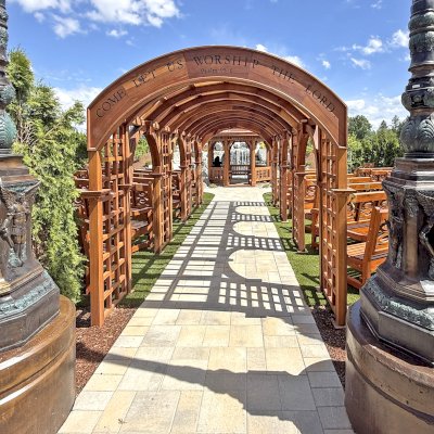 Victorian Trellis (Options: 22' x 8', California Redwood, Custom Engraving, Transparent Premium Sealant). Photo Also Shows Several Hennell Garden Benches. Trellis Installed in Faith Walk Community Fitness Park in Coeur d'Alene, Idaho.