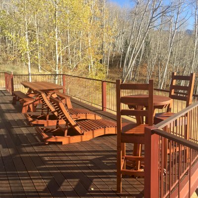 Penny Wooden Sun Lounger (Options: Single, Old-Growth Redwood, Standard 78 inches, No Armrests, Snack Trays on Right Side, 13" H, Wheels, No Cushion, Transparent Premium Sealant). Photo Also Shows a Picnic Table and a Round Cocktail Table Set. Photo Courtesy of P. Sigel of Telluride, Colorado.