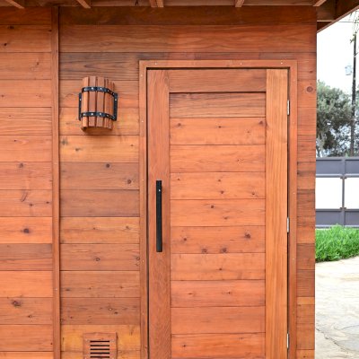 Raul’s Rad Redwood Sauna (Options: 11' W, 8' D, 11' H, California Redwood (for Interiors) & Mature Redwood (for Exteriors), Pitch Roof for Exterior Areas, "L" Shape Bench (2 levels), Transparent Premium Sealant).