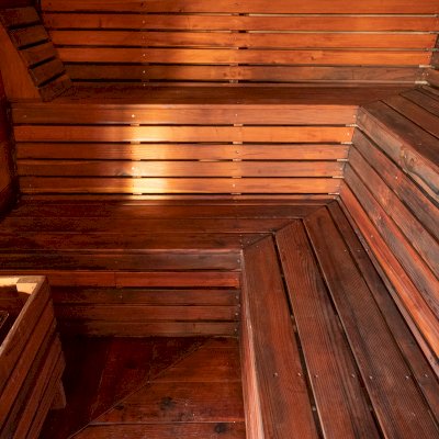Raul’s Rad Redwood Sauna (Options: 11' W, 8' D, 11' H, California Redwood (for Interiors) & Mature Redwood (for Exteriors), Pitch Roof for Exterior Areas, "L" Shape Bench (2 levels), Transparent Premium Sealant).
