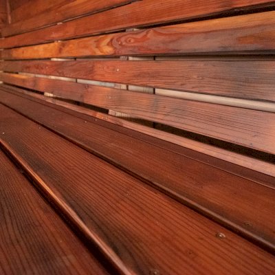 Raul’s Rad Redwood Sauna (Options: 11' W, 8' D, 11' H, California Redwood (for Interiors) & Mature Redwood (for Exteriors), Pitch Roof for Exterior Areas, "L" Shape Bench (2 levels), Transparent Premium Sealant).