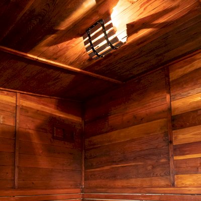 Raul’s Rad Redwood Sauna (Options: 11' W, 8' D, 11' H, California Redwood (for Interiors) & Mature Redwood (for Exteriors), Pitch Roof for Exterior Areas, "L" Shape Bench (2 levels), Transparent Premium Sealant).