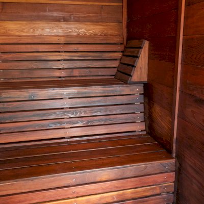 Raul’s Rad Redwood Sauna (Options: 11' W, 8' D, 11' H, California Redwood (for Interiors) & Mature Redwood (for Exteriors), Pitch Roof for Exterior Areas, "L" Shape Bench (2 levels), Transparent Premium Sealant).