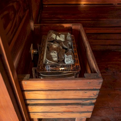 Raul’s Rad Redwood Sauna (Options: 11' W, 8' D, 11' H, California Redwood (for Interiors) & Mature Redwood (for Exteriors), Pitch Roof for Exterior Areas, "L" Shape Bench (2 levels), Transparent Premium Sealant).