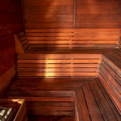 Raul’s Rad Redwood Sauna (Options: 11' W, 8' D, 11' H, California Redwood (for Interiors) & Mature Redwood (for Exteriors), Pitch Roof for Exterior Areas, "L" Shape Bench (2 levels), Transparent Premium Sealant).