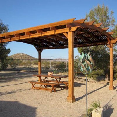 Rectangular Folding Picnic Table below Arched Pergola (Options: 72" L, 24" W, Folding Side Benches, Old-Growth Redwood, 1 Full Length Bench/Side, Standard Tabletop, Checkerboard Design, Slightly Rounded Corners, Umbrella Hole & Plug (1 5/8"), Transparent Premium Sealant). Photo Courtesy of Christine Kelley of Twentynine Palms.