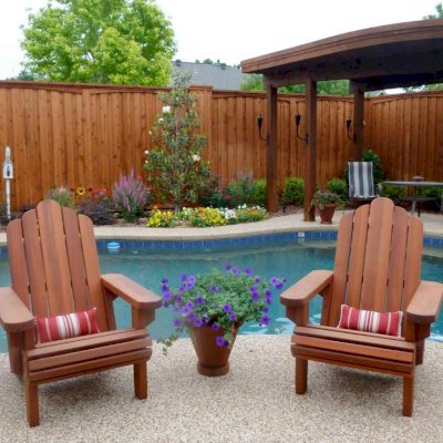 Redwood Adirondack Chair (Options: Standard Size, Old-Growth Redwood, No Cushion, Transparent Premium Sealant). Vase Planters also in Old-Growth Redwood. Photo Courtesy of Ms. Cyndie Bertrand of Plano, TX.  Small back support cushions are a custom item.