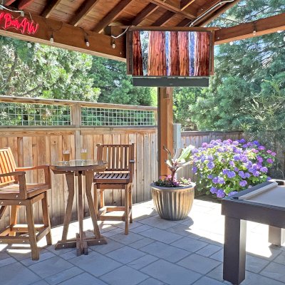 Redwood Cocktail Bar Stools (Options: Mature Redwood, Arms, Swivel Seat, 23" H, No Cushion, Transparent Premium Sealant). Photo Also Shows a Round Cocktail Table and a Del Norte Pavilion.