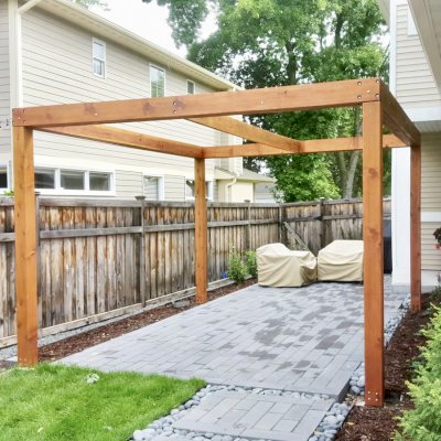 Retractable Canopy Pergola (Options: 14' L x 12' W, No Privacy Panel, California Redwood, 9 ft Post Height, No Electrical Wiring Trim, Replaced Our Anchor Kit with a Knife Plate Connector System to Achieve a More Modern Way to Attach the Posts, No Post Decorative Trim, No Ceiling Fan Base, No Curtain Rods, Transparent Premium Sealant). Photo Courtesy of B. Sill of Edina, Minnesota.
