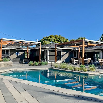 Retractable Canopy Pergola (Options: 17' L x 16' W, No Privacy Panel, California Redwood, 9.5 ft Post Height, No Electrical Wiring Trim, Replaced Our Anchor Kit with a Knife Plate Connector System to Achieve a More Modern Way to Attach the Posts, No Post Decorative Trim, No Ceiling Fan Base, No Curtain Rods, Transparent Premium Sealant). Photo Courtesy of P. Moran of San Jose, CA.