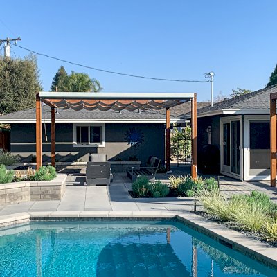 Retractable Canopy Pergola (Options: 17' L x 16' W, No Privacy Panel, California Redwood, 9.5 ft Post Height, No Electrical Wiring Trim, Replaced Our Anchor Kit with a Knife Plate Connector System to Achieve a More Modern Way to Attach the Posts, No Post Decorative Trim, No Ceiling Fan Base, No Curtain Rods, Transparent Premium Sealant). Photo Courtesy of P. Moran of San Jose, CA.