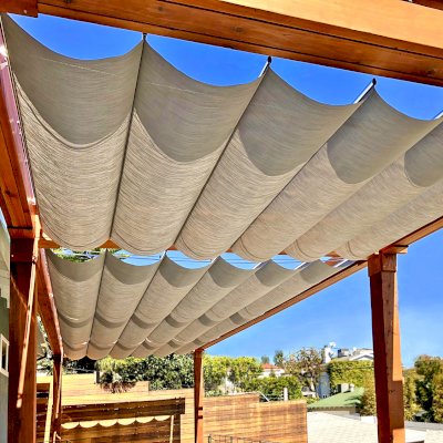 Retractable Canopy Pergola (Options: 30' L x 12' W, No Privacy Panel, Mature Redwood, 8 x 8 Posts by Custom Request, 10 ft Post Height, No Electrical Wiring Trim, Post Anchor Kit for Concrete, No Post Decorative Trim, No Ceiling Fan Base, No Curtain Rods, Transparent Premium Sealant, Overhang of Supports by Custom Request). Photo Courtesy of J. Herr of Venice, CA.