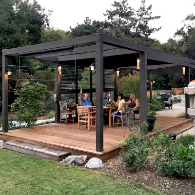 Custom Retractable Canopy Pergola (Options: 40' L x 14' W, 1 Privacy Panel Louvered, Douglas-fir, With Louvered Panels in the Center Section of the Roof, 10 ft Post Height, 8-Post Anchor Kit for Concrete, No Electrical Wiring Trim, No Post Decorative Trim, No Ceiling Fan Base, No Curtain Rods, Custom Paint). Photo Courtesy of R. Clark of Carmel Valley, California.