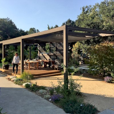 Custom Retractable Canopy Pergola (Options: 40' L x 14' W, 1 Privacy Panel Louvered, Douglas-fir, With Louvered Panels in the Center Section of the Roof, 10 ft Post Height, 8-Post Anchor Kit for Concrete, No Electrical Wiring Trim, No Post Decorative Trim, No Ceiling Fan Base, No Curtain Rods, Custom Paint). Photo Courtesy of R. Clark of Carmel Valley, California.