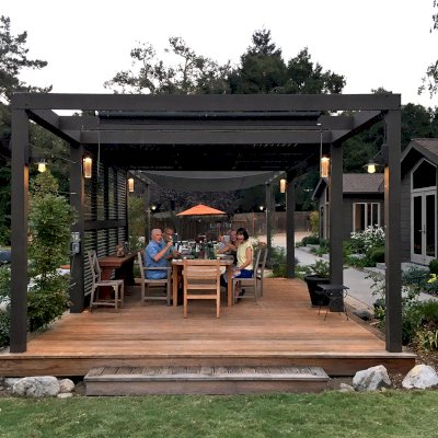 Custom Retractable Canopy Pergola (Options: 40' L x 14' W, 1 Privacy Panel Louvered, Douglas-fir, With Louvered Panels in the Center Section of the Roof, 10 ft Post Height, 8-Post Anchor Kit for Concrete, No Electrical Wiring Trim, No Post Decorative Trim, No Ceiling Fan Base, No Curtain Rods, Custom Paint). Photo Courtesy of R. Clark of Carmel Valley, California.