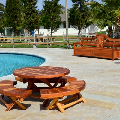 Round Folding Wood Table for Kids (Options: 42" Diameter, Redwood, 3 Folding Benches, No Umbrella Hole, Standard Tabletop, Transparent Premium Sealant). Alan's Storage Bench shown in background.