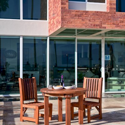 Round Outdoor Patio Table (Options: 3 1/2', 2 Chairs, Mature Redwood, Ruth Chairs, No Cushions, Side Chairs only (no arms), Standard Tabletop, No Lazy Susan, No Umbrella Hole, Transparent Premium Sealant).  Photo Courtesy of The Estero Beach Resort of Ensenada, Mexico. 
